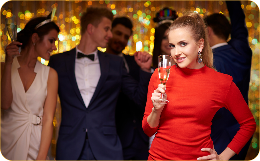Elegantly dressed guests celebrating at a glamorous event with golden bokeh background
